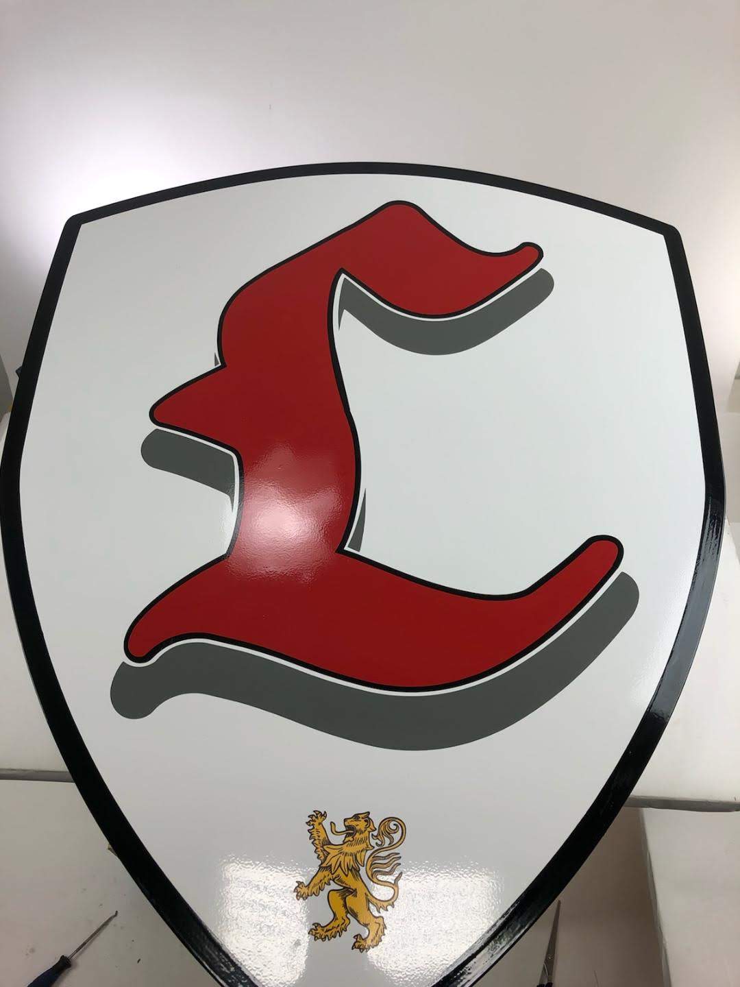 Letter L printed on a white shield with black border